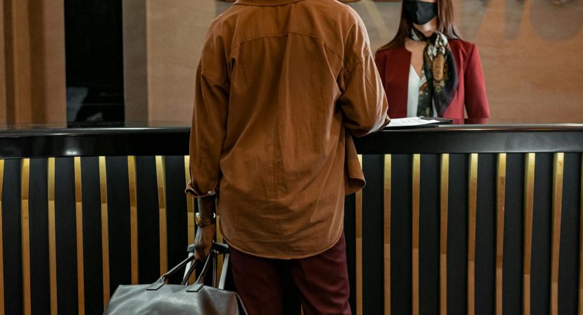 A Guest Talking to a Woman at the Reception Area