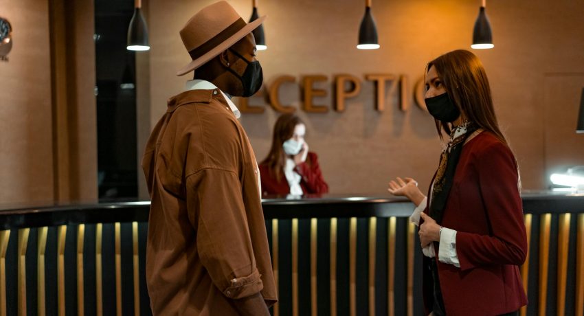 A Man and a Woman Talking at the Reception Area